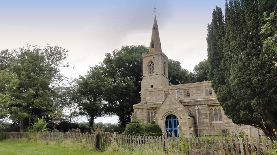 The old church at Steeple Gidding, currently closed, surrounded by a wooden fence